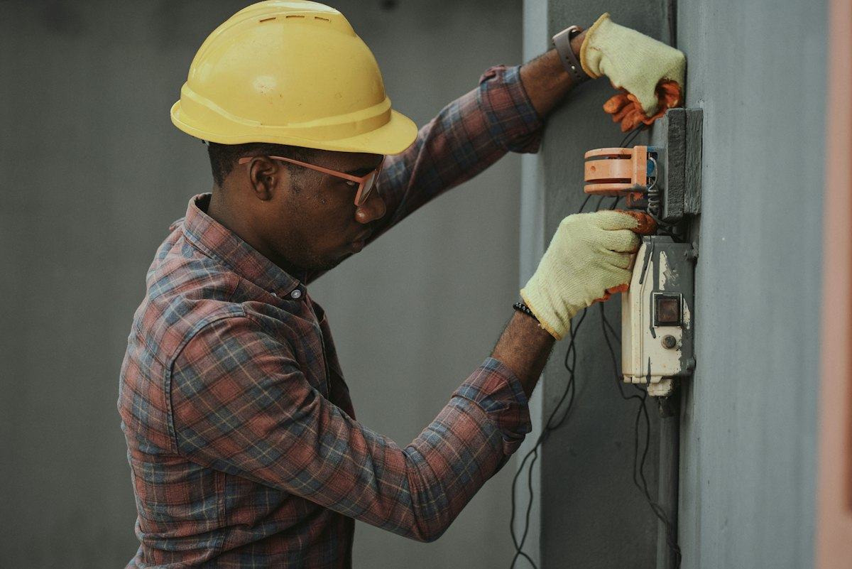 A Dorzi technician working on a wall-mounted unit during a service call